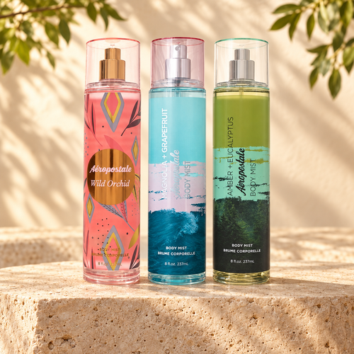 Three example Aeropostale body mists—Wild Orchid, Magnolia + Grapefruit, and Amber + Eucalyptus—on a sunlit stone display. Choose any three eligible scents.